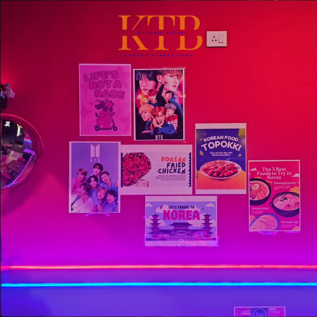K-pop and K-drama poster wall inside K-Town Bites