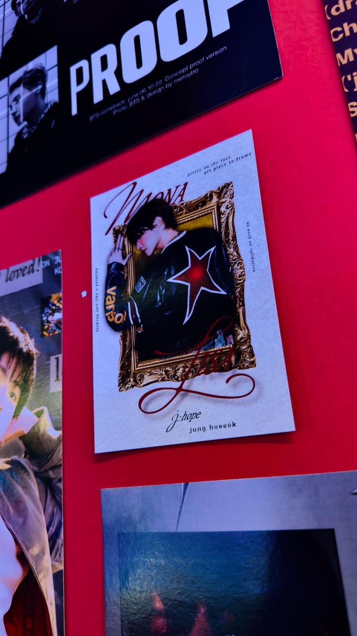 J-Hope poster framed on a red wall
